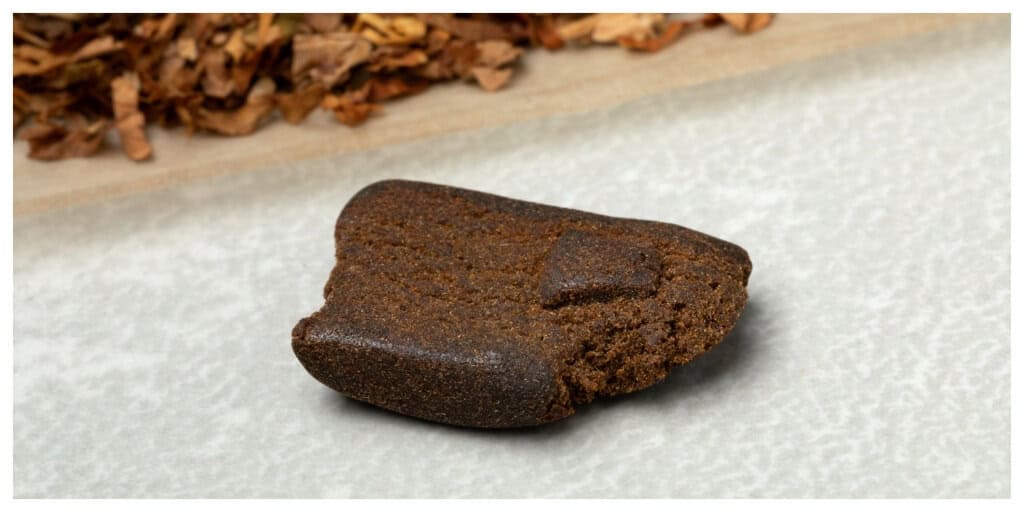 A piece of afghan hash on white background close up