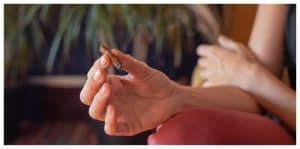 Close up shot of a woman's hand holding a blunt