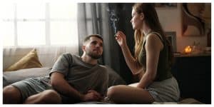couple smoking in a cozy bedroom
